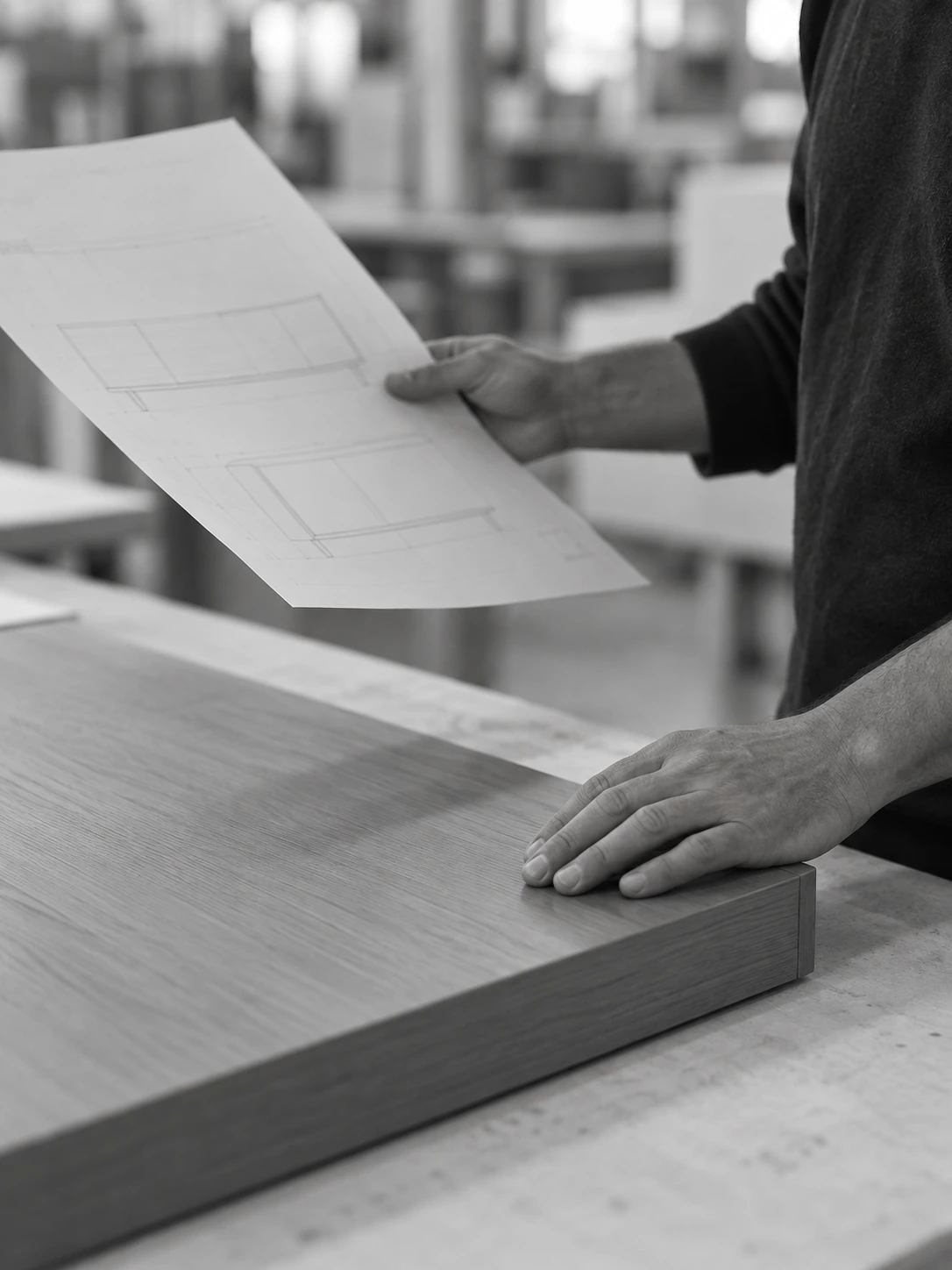 A coordinator comparing a finished furniture panel with an execution drawing