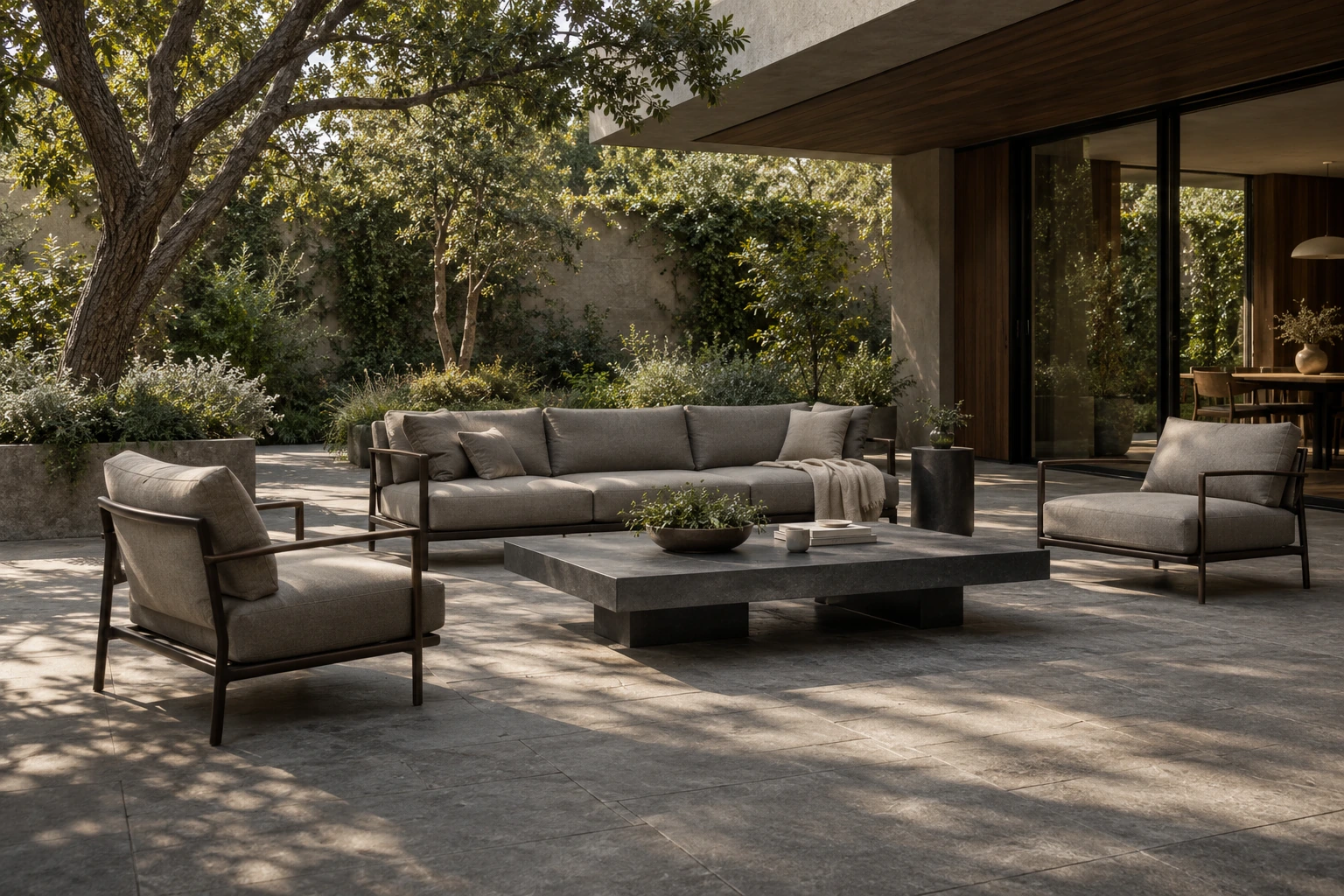 Concept garden terrace with upholstered outdoor seating, dark metal frames and a stone coffee table